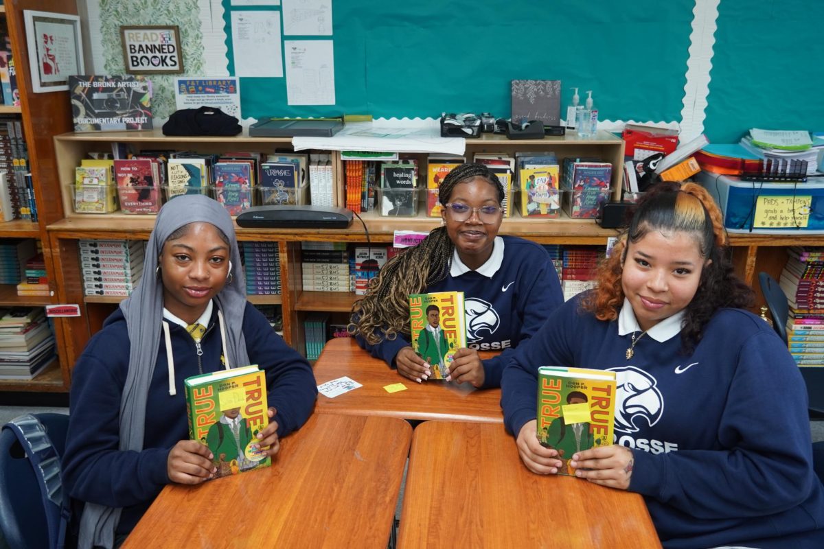 Juniors holding up their signed copies of True True.